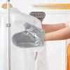 A silver triple insulated steam glove is shown being placed onto a white garment.
