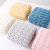A collection of textured bath towels in yellow, blue, gray, and pink.