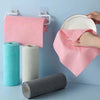 A pink microfiber tear-off cleaning cloth is hanging on a hook next to rolls of cleaning cloths in teal, beige, and gray.