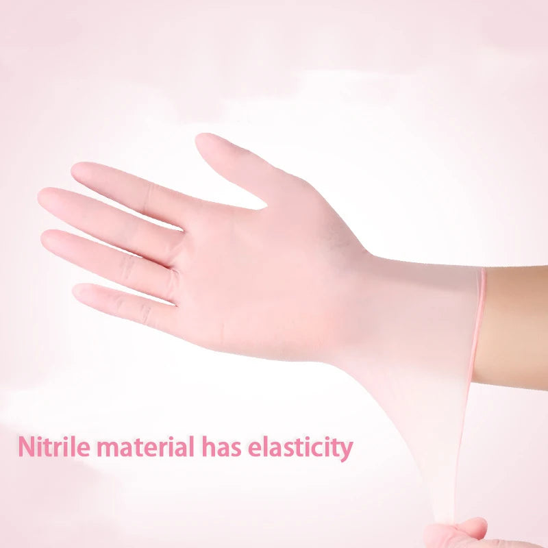 A hand wearing a pink nitrile cleaning glove demonstrates the elasticity of the material.