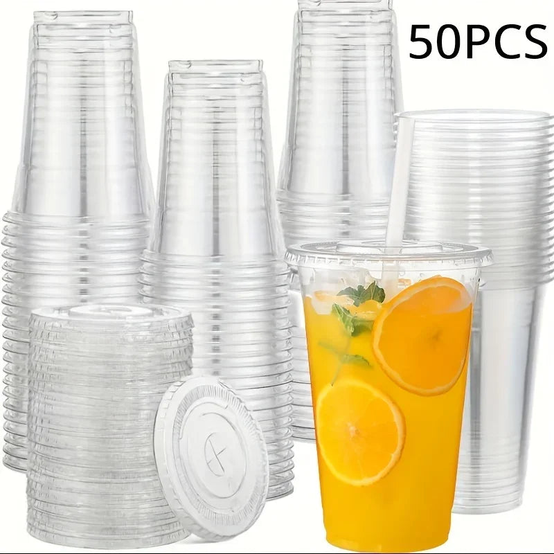 A collection of clear reusable plastic cups with lids and a glass of orange juice