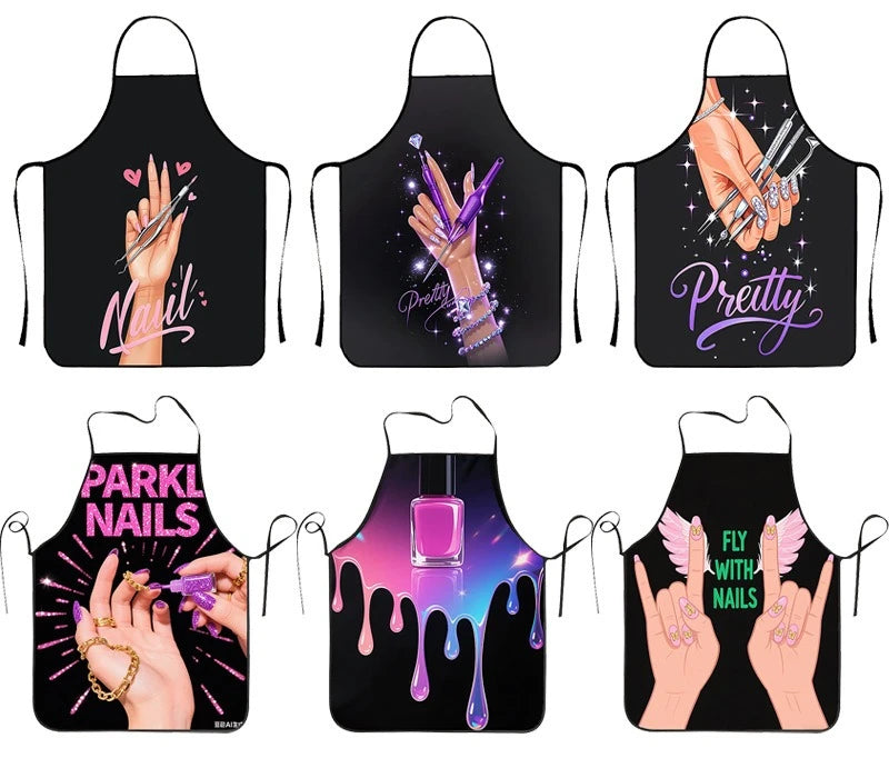 A set of black aprons featuring various nail-themed designs including handprints, glitter, and text like Pretty and Pink Nail