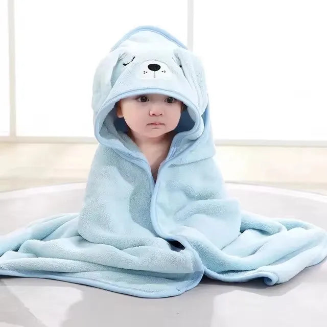 Baby in light blue soft cotton towel and swaddle set with a hood