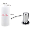A white under-sink kitchen soap dispenser with a silver pump and a long spout.