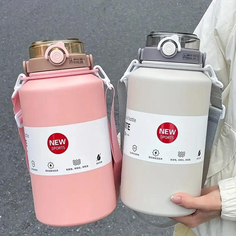 A pink insulated tumbler with a lid and straw is held by a person, next to a white bottle.