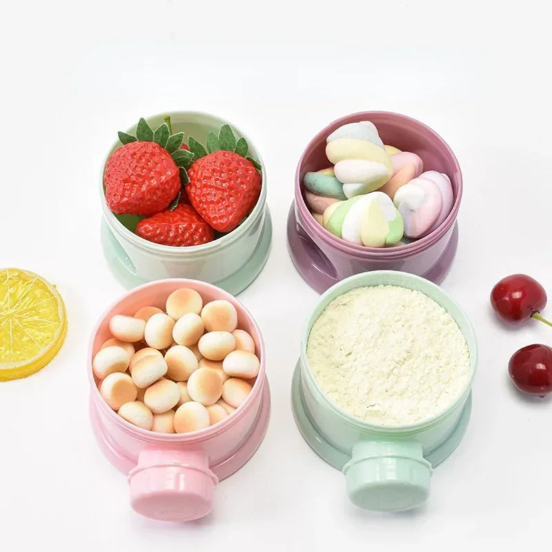 A collection of colorful silicone food storage boxes filled with various baby snacks like strawberries and fruit pieces.
