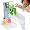 A silver faucet extender with a green rabbit design and various colored silicone nozzles for a baby
