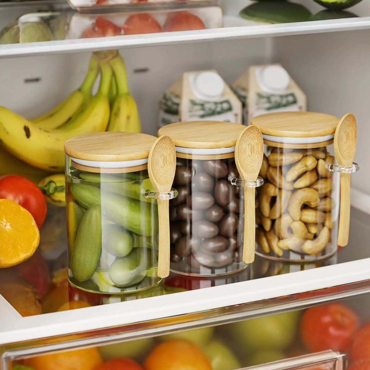 A row of airtight glass spice jars with bamboo lids filled with various dried ingredients like peppercorns and nuts.