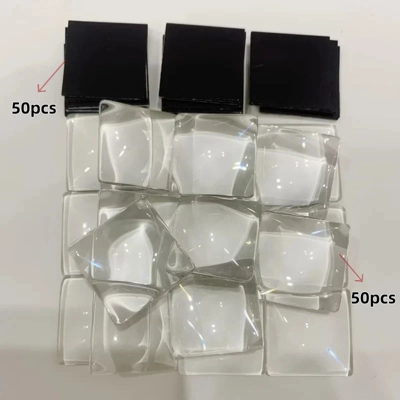 A collection of clear glass refrigerator magnets and black magnetic pieces.