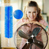 A woman holds a large, dark-colored cleaning brush in front of her face, with a blue cleaning brush visible nearby.