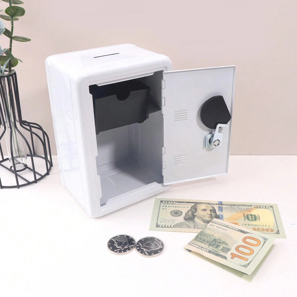A white metal piggy bank with a combination lock is shown open, displaying coins and paper currency.