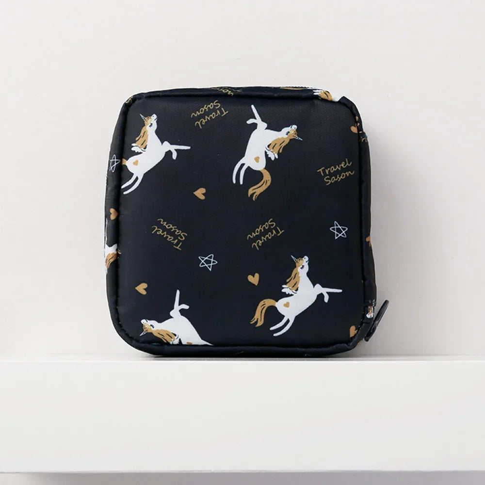Black pouch with a floral pattern featuring silhouette drawings of horses and text reading Travel Season