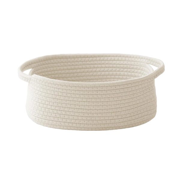 A beige handwoven rope storage basket with handles, shown from above.
