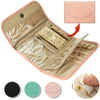 A pink foldable waterproof jewelry organizer bag open to show various jewelry and accessories.