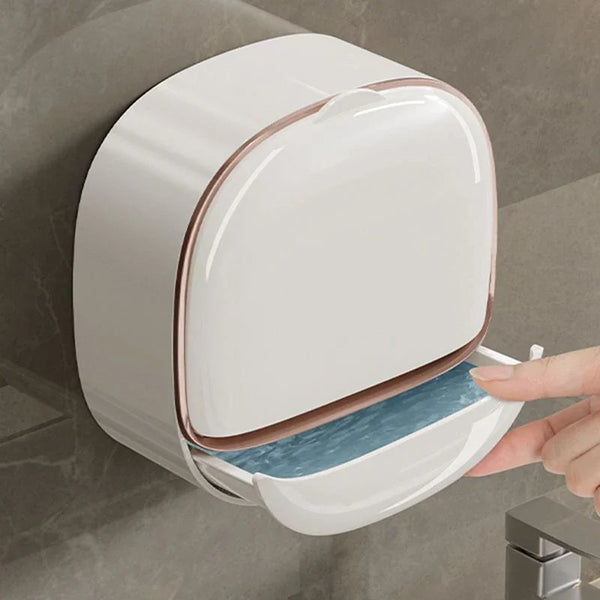 A white wall-mounted soap dish with a lid is shown being opened by a hand.