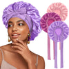 A woman models a purple satin sleeping cap with pink and purple fabric accents.