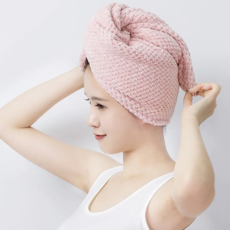 A woman is shown wearing a pink soft microfiber hair drying towel wrap.