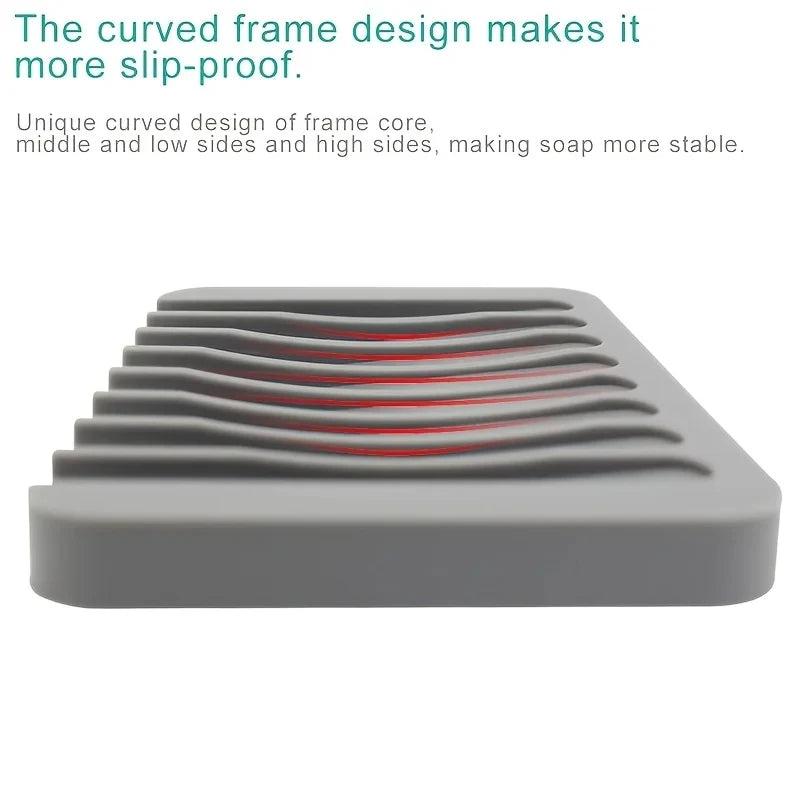 A gray silicone soap dish with a unique curved design featuring multiple ridges for stability.