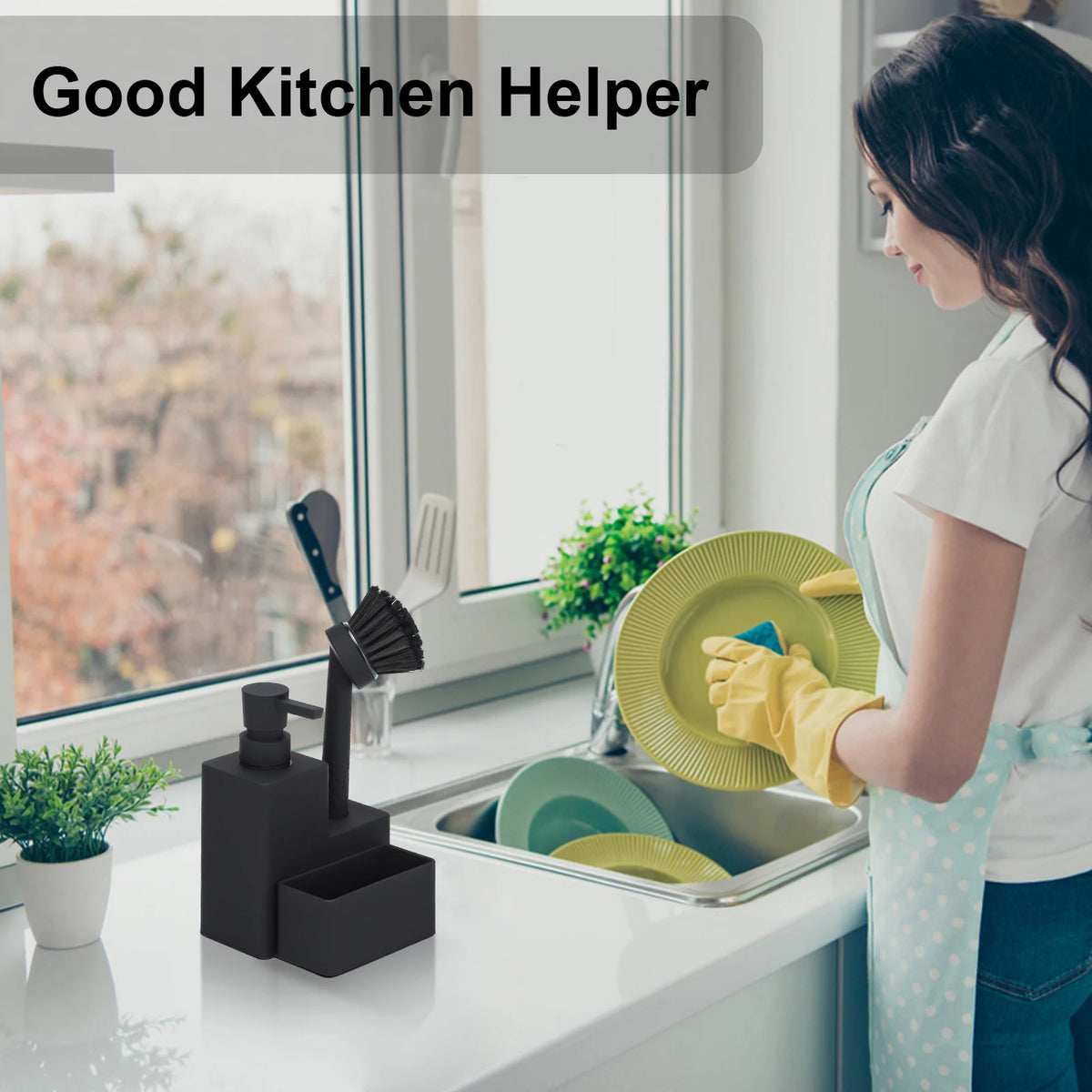 A woman is using a black kitchen helper soap dispenser with a sponge holder and brush on a kitchen counter.