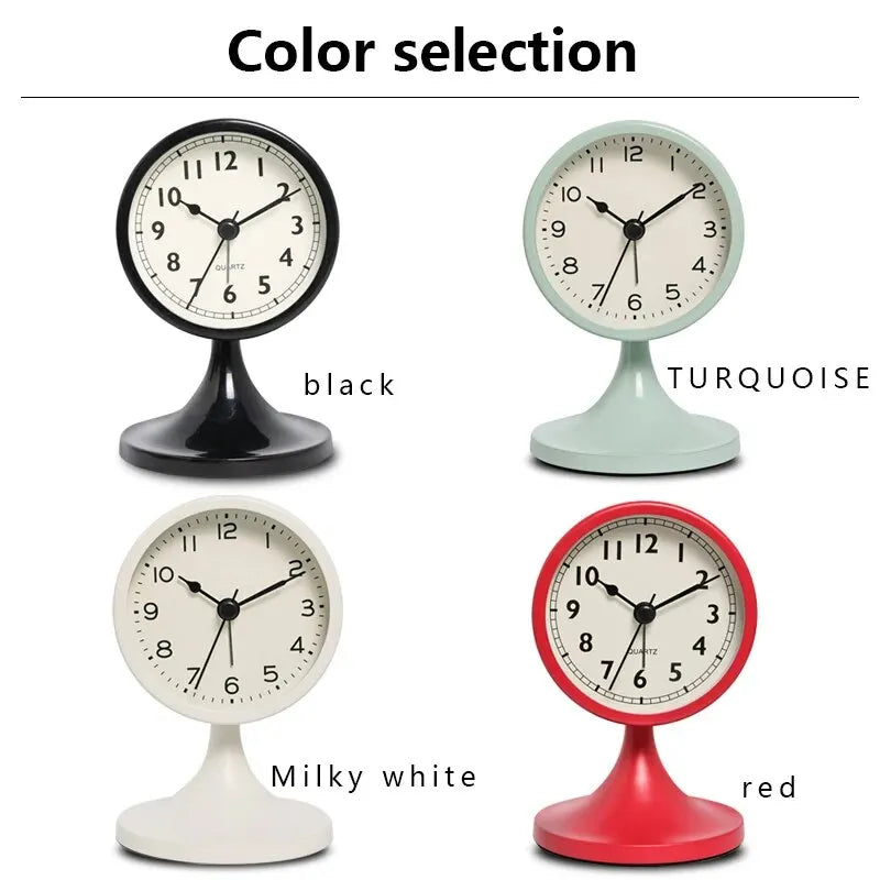 A selection of five round alarm clocks in black, turquoise, milky white, and red colors.