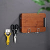 A wooden sponge holder rack with a stainless steel knife and a yellow suction cup tool displayed on a gray background.
