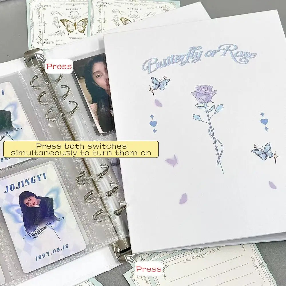 A photo album featuring butterfly and rose designs on loose leaf pages.