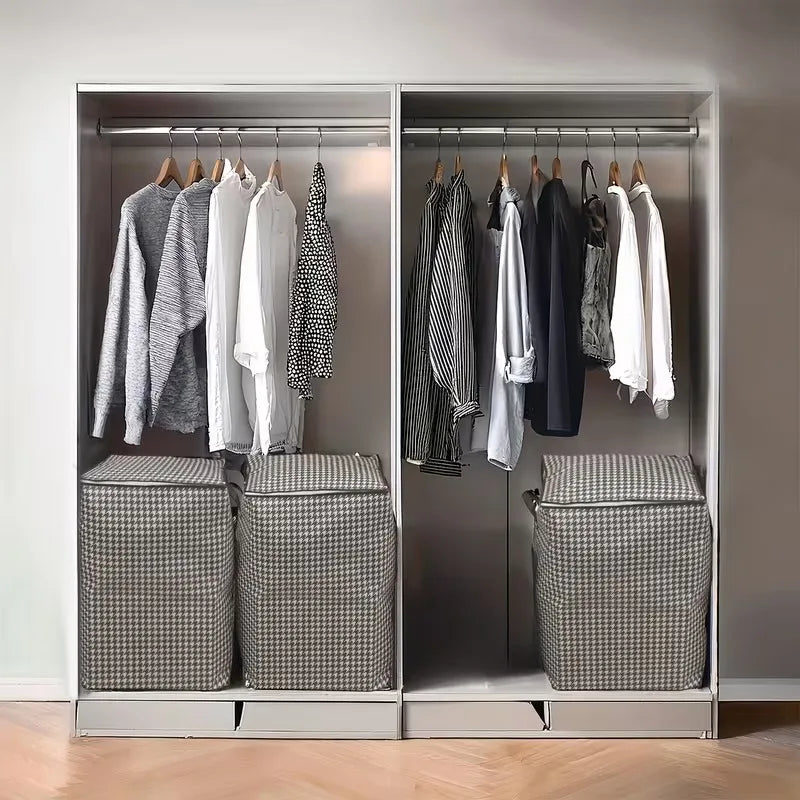 A closet organizer displaying hanging clothes and storage boxes for quilts in a modern wardrobe.