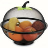A black metal fruit basket with a mesh cover holding various fruits and topped with a green leaf handle.