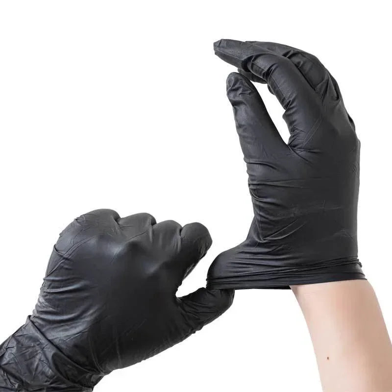 A hand wearing a black disposable nitrile cleaning glove is shown against a white background.