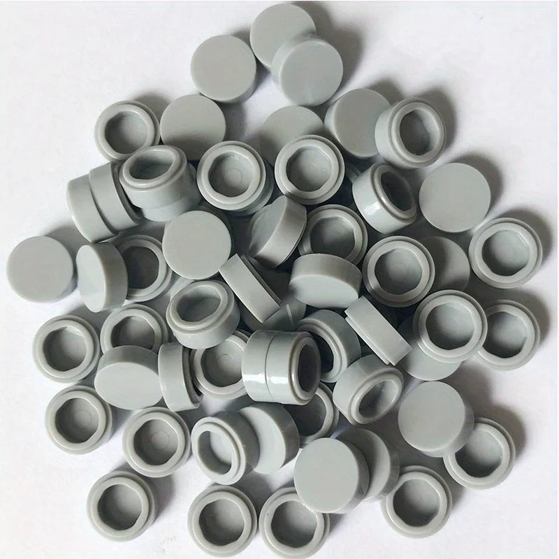 A collection of round, gray building blocks or components for DIY projects.