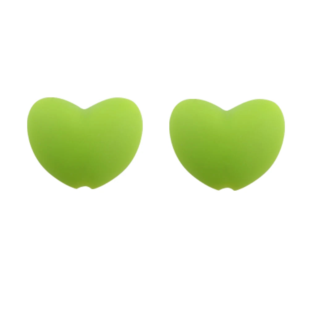 A pair of bright lime green silicone heart-shaped charm beads for DIY jewelry.