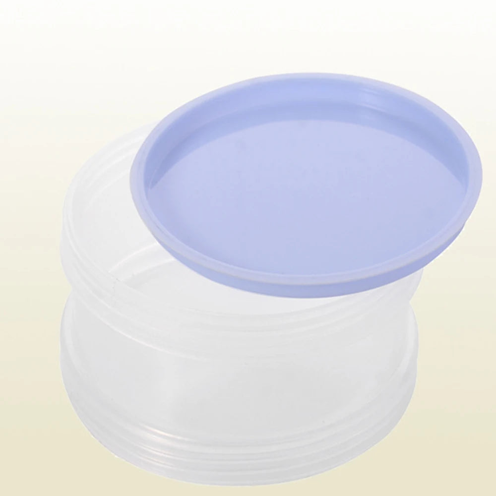 A clear plastic container with a purple lid and base for storing milk powder.
