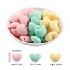 A collection of ten hot heart silicone charm beads in pink, mint green, and light yellow colors.