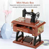 A wooden mini music box featuring a vintage clockwork sewing machine on top and a storage lattice below.