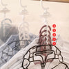Five hanging vacuum storage bags for bulky clothing displayed on a clear plastic hanger.