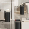 A black odor-sealing trash can with a press lid is shown in a modern bathroom setting.