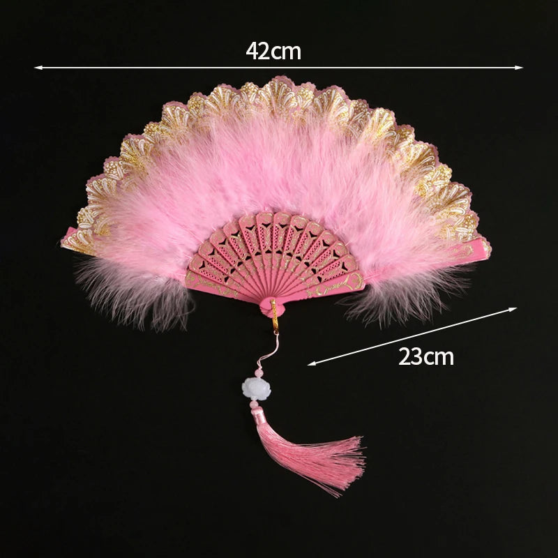 Pink lace fabric folding hand fan with gold trim and a tassel