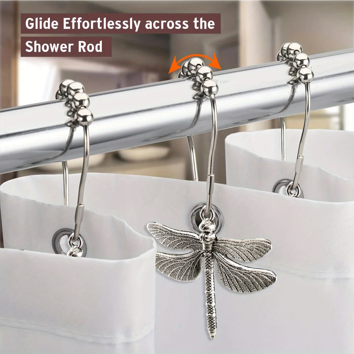 A set of silver dragonfly shower curtain hooks gliding effortlessly across a metal shower rod.