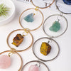 Gold-toned circular crystal healing ornaments featuring various natural stones like turquoise, amber, and rose quartz.
