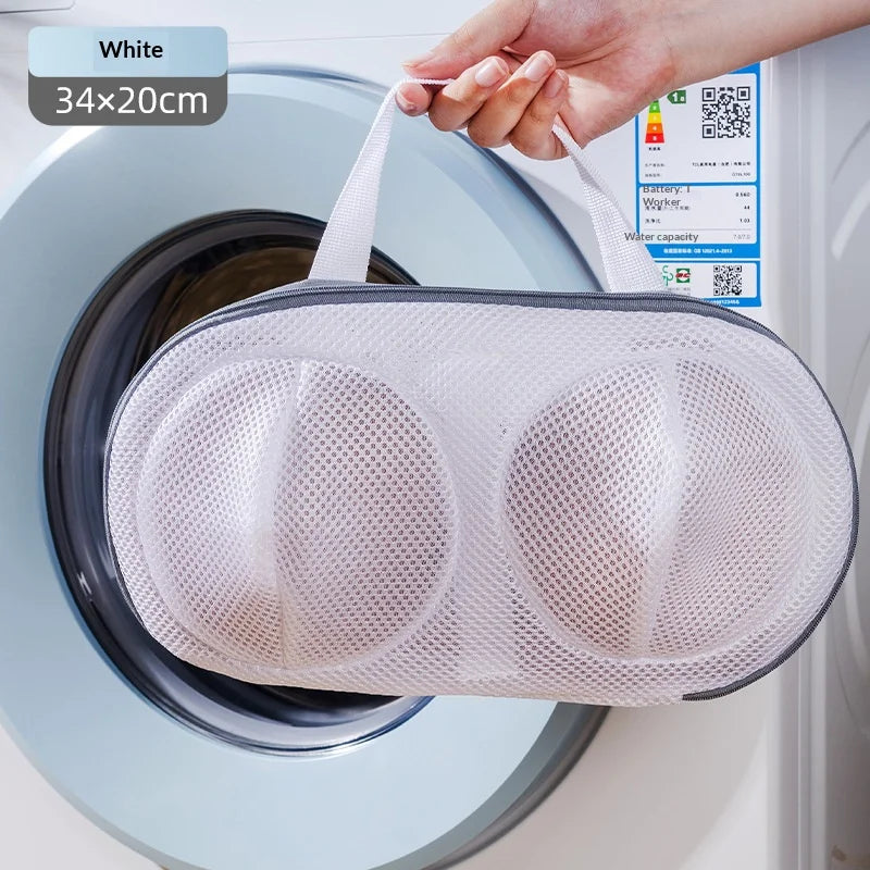 A white mesh laundry bag is shown inside a washing machine drum, demonstrating its use for protecting delicate items.