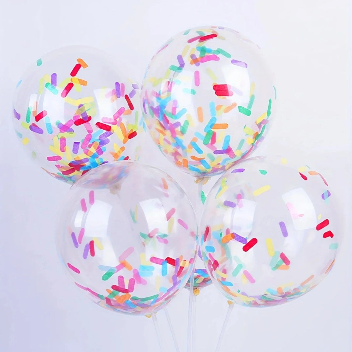 A cluster of clear balloons filled with colorful confetti decorations