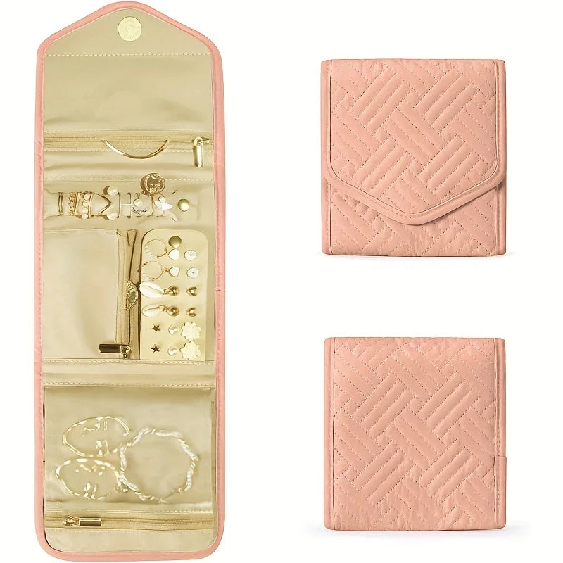 A pink foldable waterproof jewelry organizer bag showing various compartments and jewelry storage.