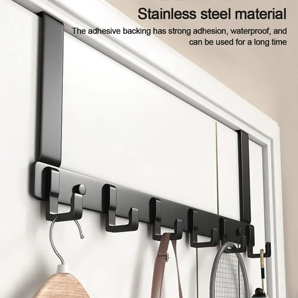 Black stainless steel adhesive door hooks mounted on a white wall.
