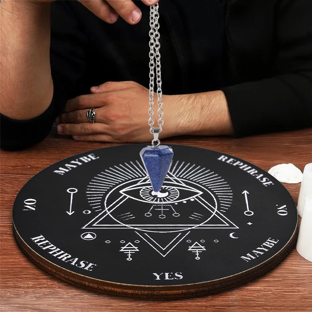 A wooden divination altar set featuring a dark circle with symbols and a hanging crystal pendant necklace.