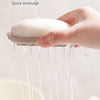 A hand is pouring liquid from a white soap dish, demonstrating quick drainage.