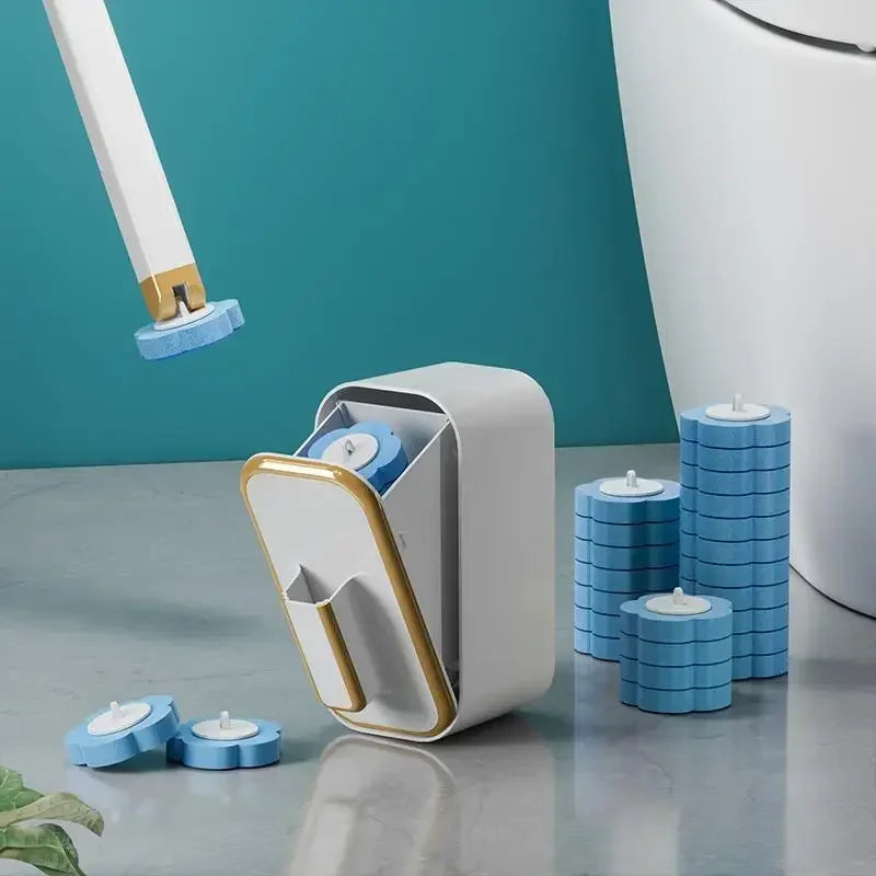 A white reusable toilet brush holder with blue cleaning brushes on a gray surface.