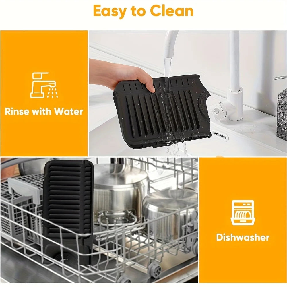 Black silicone kitchen sink splash guard being rinsed with water.