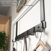 A close-up of heavy-duty adhesive door hooks mounted on a white wall, showing multiple storage options.