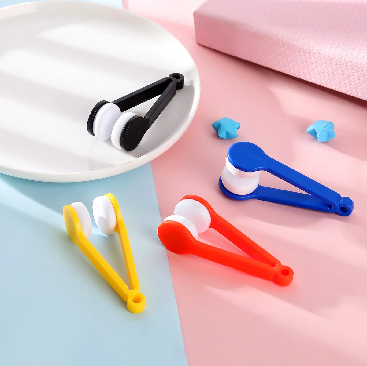 A collection of colorful two-sided microfiber cleaning brushes for eyeglasses, including black, white, blue, and orange.