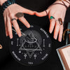 A hand holds a black wooden divination altar featuring geometric symbols and text like REPHRASE, YES, and MAYBE.